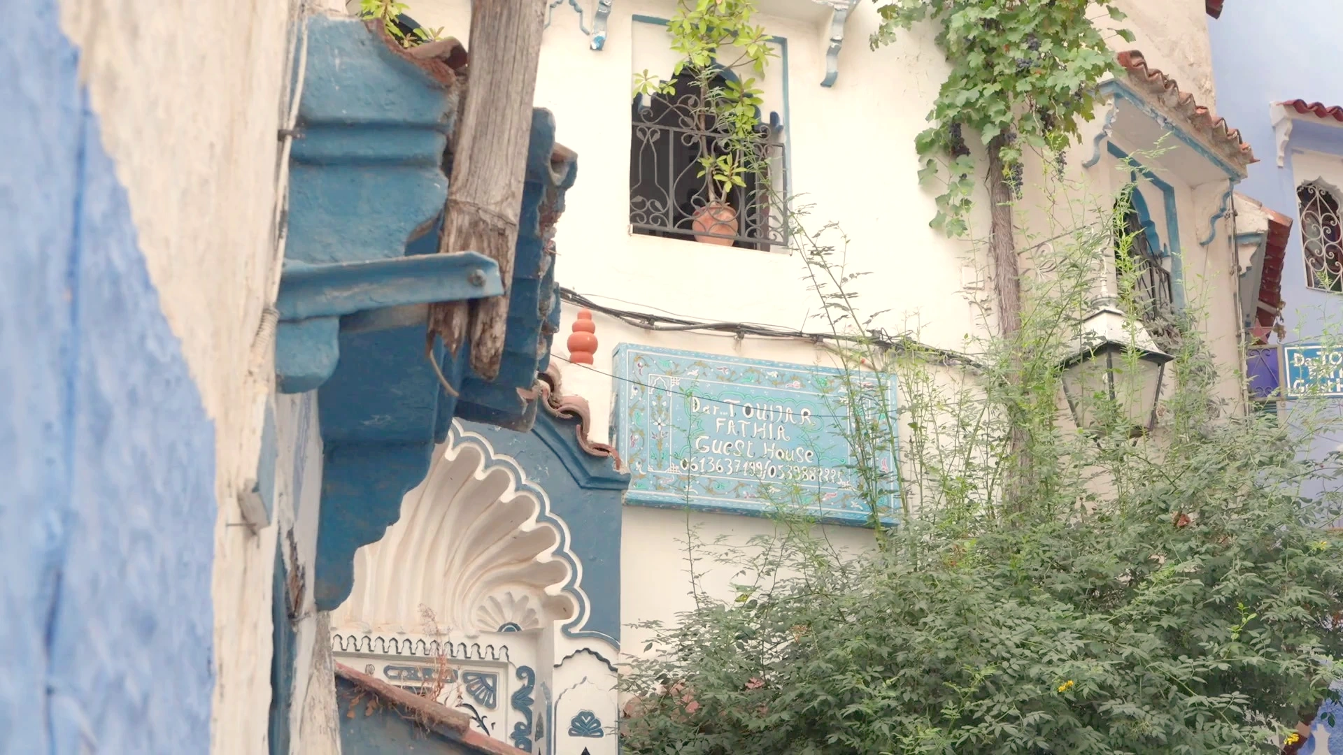 Chefchaouen Medina: Intricate Facade Carvings & Guest House Signage
